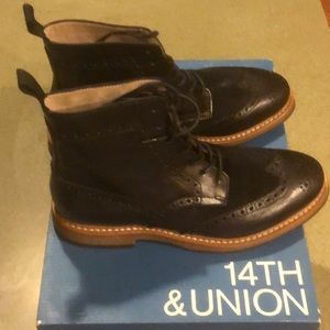 Black leather & suede wingtip boots.